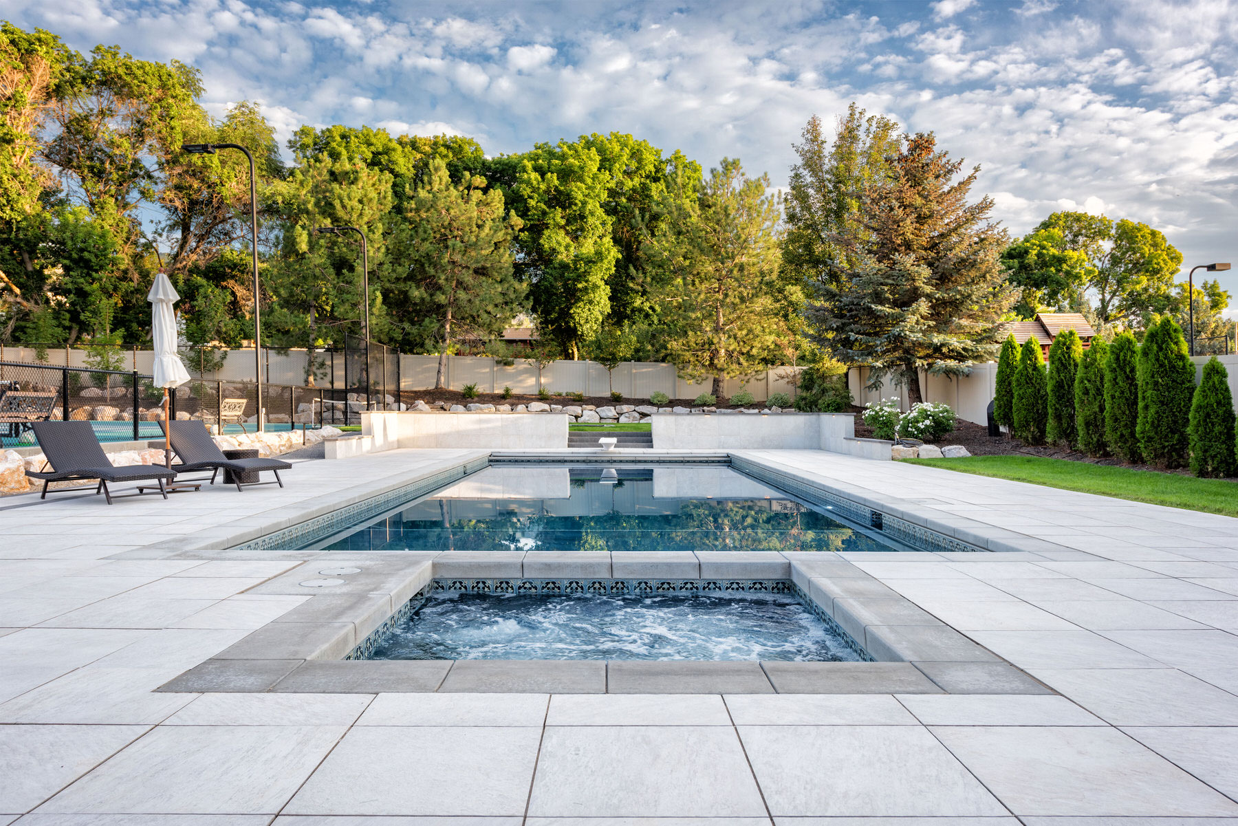 Swimming pool with decorative tiles in private garden - Precision Pools